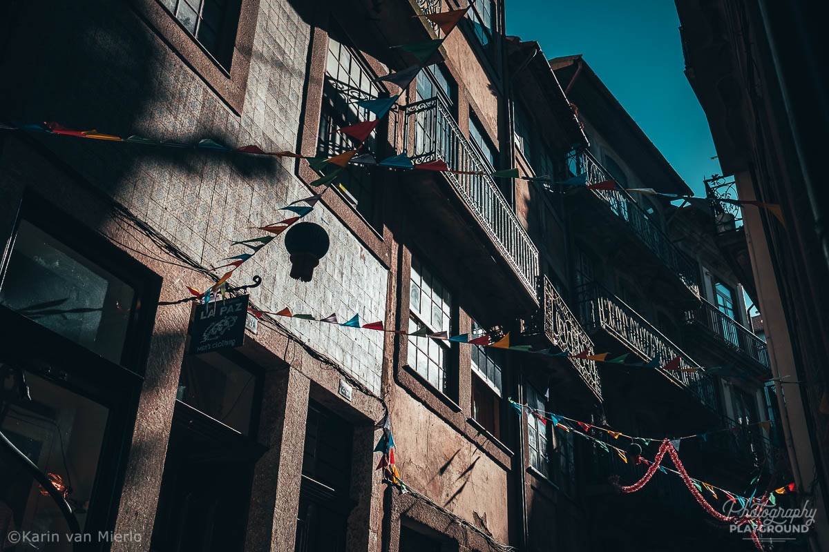 street photography ideas, street photography tips, how to start street photography, street photography cameras | Copyright Karin van Mierlo for Photography Playground. Photo: flags in the streets of Porto, Portugal