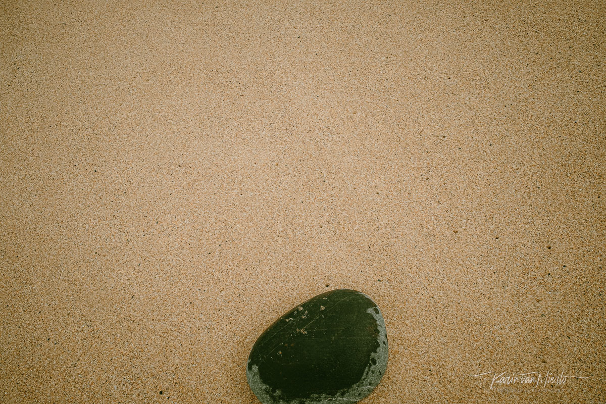 summer photography ideas | Copyright Karin van Mierlo, Photography Playground. Photo: A large pebble on a deserted, wet beach, Vila Nova de Milfontes, Portugal